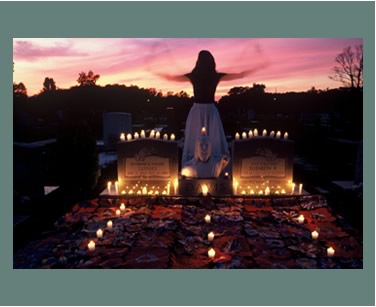 <b>Audrey Bland Howard (the spirit figure) at the gravesite of Ulysses Davis (1913-1990)</b>, a master folk woodcarver, and his wife Elizabeth Davis (1917-1984), a quilter.  The quilt on the grave was made by Joseph White of Charleston, South Carolina.  Chatham County, GA, October 1993.
