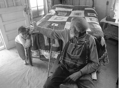 <b>Eltha and her great-grandfather James 'Highpocket' Lee who made the quilt on the bed.</b> Houston County, AL 1990